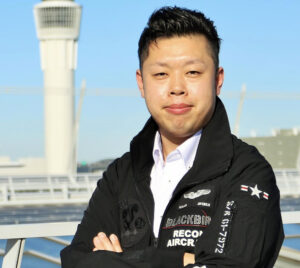 元航空管制官田中ひでたかさんの画像。腕組みをして凛々しい印象。